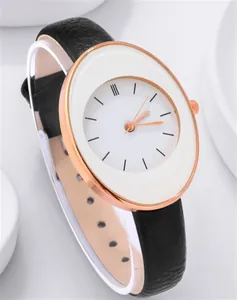 Close-up of minimalist women's watch featuring a rose gold case and black leather strap