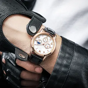 Detail of rose gold men's watch with white dial, roman numerals and black leather strap