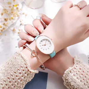 Close-up of elegant mint green leather strap watch and matching rose gold knot bracelet