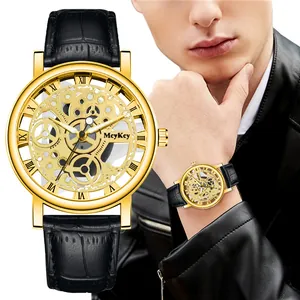 Macro view of gold skeleton dial with roman numerals and black leather watch strap