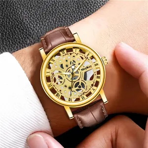 Men's luxury skeleton mechanical watch with gold case and brown leather strap on wrist