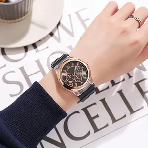 Detail einer roségoldenen achteckigen Uhr mit schwarzem Silikonarmband am Handgelenk