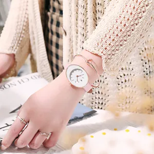 Detail of pink leather watch set with rose gold knot bracelet and butterfly rings on wrist