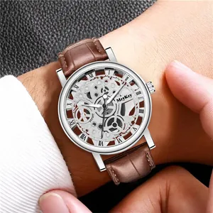 Close-up of skeleton quartz watch on wrist with brown leather strap and Roman numerals