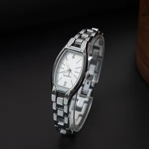Silver tonneau quartz watch for women with polished metal link strap on black background