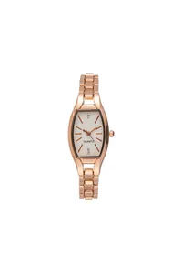 Macro detail of tonneau quartz watch featuring rose gold link band and crystal indices