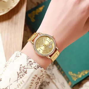 Elegant gold quartz watch for women with rhinestone bezel and double heart dial design