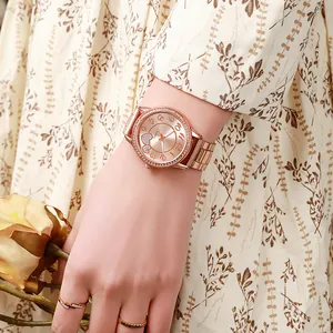 Women's rose gold quartz watch with rhinestone bezel and heart design metal strap