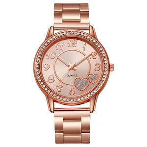 Detail of rose gold alloy quartz watch with crystal bezel and heart motif dial