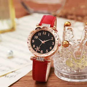 Detailopname van rood leren horloge met roségouden kast en fonkelende kristallen details