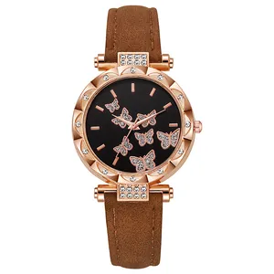 Close-up of butterfly dial and rhinestone-encrusted rose gold watch bezel detail