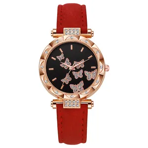 Detail of rose gold watch case with crystal bezel and black butterfly patterned dial