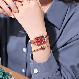 Vintage rose gold rectangular watch with red radial dial and milanese mesh bracelet