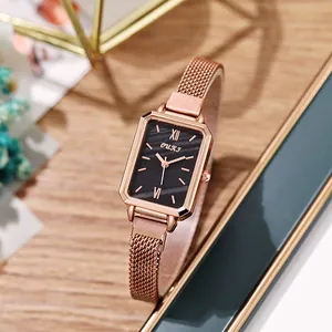Close-up of elegant rose gold rectangular watch with black dial and Milanese mesh strap