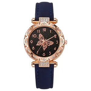 Reloj de mujer oro rosa con correa de cuero azul y esfera estrellada de mariposa