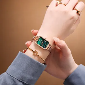 Vintage green rectangular quartz watch with gold mesh band and matching accessories