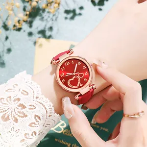 Vintage heart watch for women with red suede strap and rose gold case in lifestyle shot