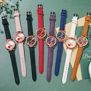 Flat lay of retro heart-patterned watches in eight colors with rose gold finish