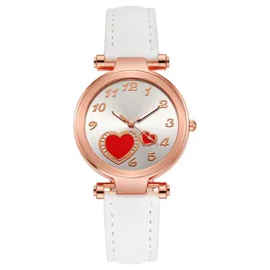 Detail of rose gold heart watch with white leather strap and silver dial numerals