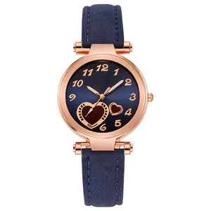 Detail of rose gold case and navy blue dial with heart accent on a minimalist watch
