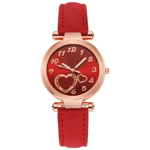 Close-up of red heart dial watch with rose gold case and frosted leather strap