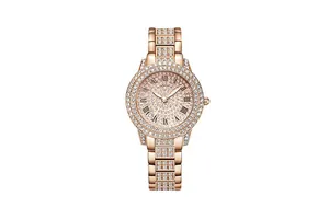 Detailed macro view of rose gold watch dial with Roman numerals and sparkling crystals