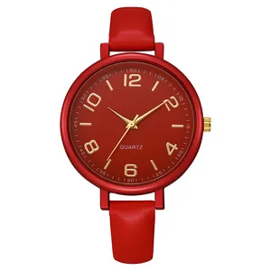 Detail of red leather strap with natural texture and golden dial indices on quartz watch
