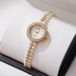 Detail of elegant ladies' watch with mother of pearl dial and pearl bead strap