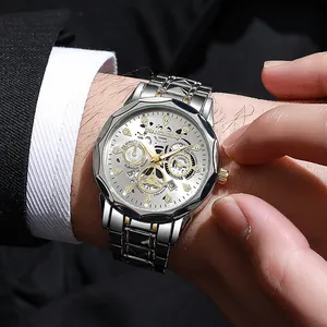 Detail of luxury men's two-tone steel watch featuring skeleton dial and rhinestone markers