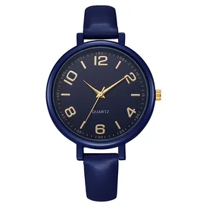 Close-up of a vintage navy blue quartz watch with gold numerals and leather strap