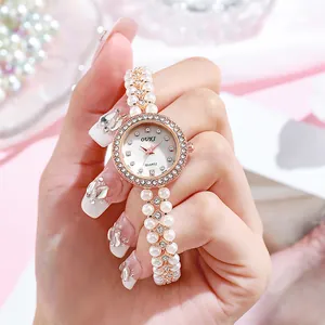Elegant women's quartz watch with pearl bead bracelet and crystal bezel on pink silk