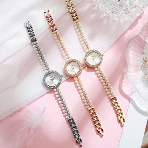 Elegant pearl strap quartz watch for women with rhinestone bezel in three metallic tones