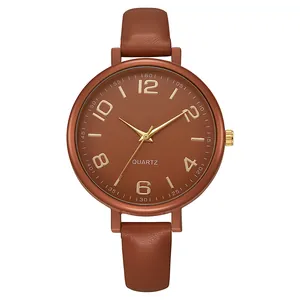 Macro shot of brown leather watch strap texture and vintage dial with gold numerals
