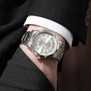 Macro detail of men's business watch with luminous gold dial and steel strap