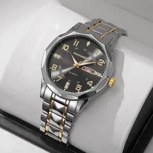 Macro shot of quartz business watch with silver-gold steel strap and date window