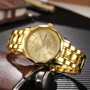 Detail shot of golden quartz watch dial with crystal indices and day-date display