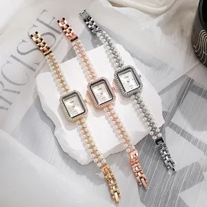 Detailed macro shot of vintage rectangle pearl bracelet watches in gold and silver