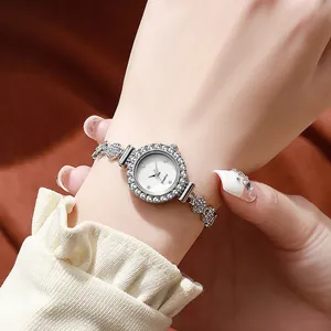 Elegant silver quartz watch for women with rhinestone bezel and floral link bracelet