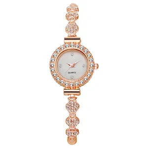 Elegant rose gold women watch with rhinestone bezel and decorative charm bracelet strap