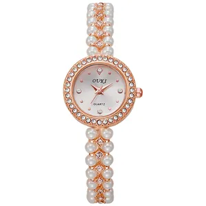 Elegant rose gold women's watch with pearl beaded strap and diamond-encrusted bezel