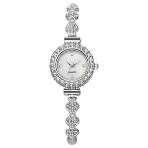 Detailed close-up of clover shaped silver watch links with sparkling crystals and diamonds
