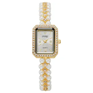Elegant gold pearl strap watch for women with a rectangular crystal-encrusted dial