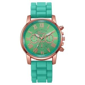 Detailed close-up of teal silicone watch strap with rose gold metal casing and dial