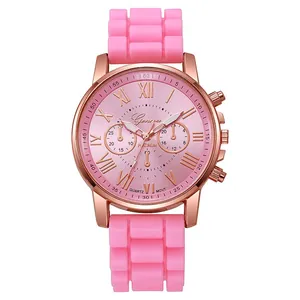 Close-up of pink silicone strap and rose gold quartz watch dial with Roman numerals