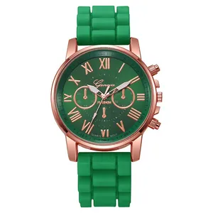 Detail of emerald green silicone strap and rose gold roman numeral quartz watch