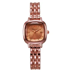 Detail of a square rose gold watch with sunray bronze dial and Roman numerals markers