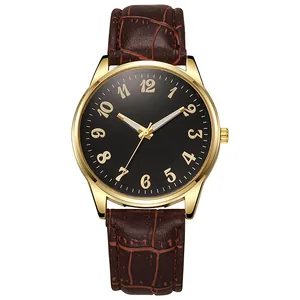 Macro detail of men's business watch with black dial, gold numerals, and brown leather strap