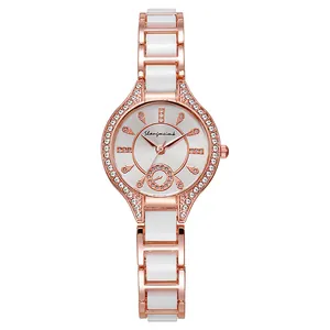 Detailed macro view of rose gold quartz watch with ceramic links and crystal bezel