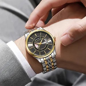 Detail of silver and gold stainless steel watch band worn with a formal grey suit