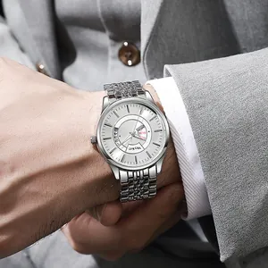 Detailed view of a men's silver steel watch with white dial on a business suit wrist